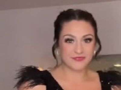 Tati Evans is wearing a black sleeveless dress.